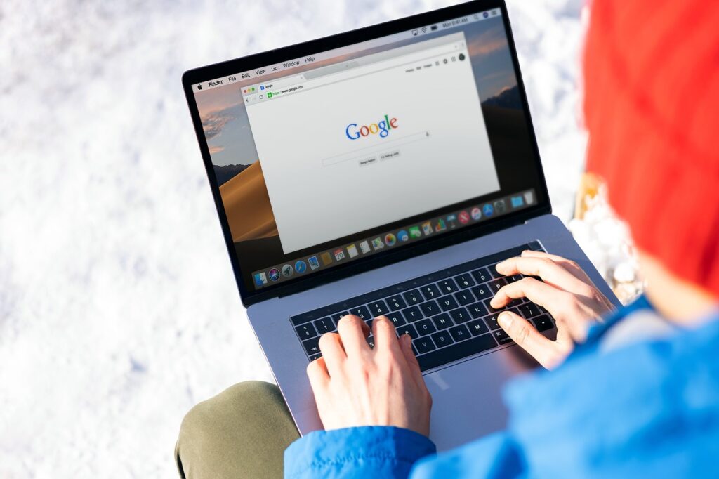 freelance, work, google, laptop, computer, apple product, macbook, macbook pro, hands, man hands, keyboard, winter, blue jacket, red hat, google, google, google, google, google